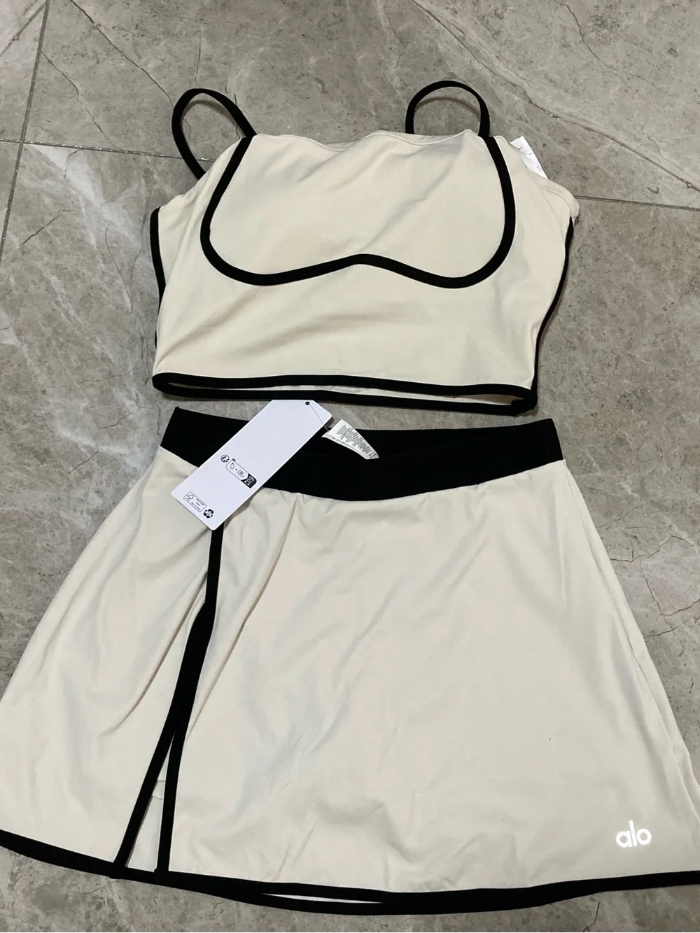 ALO Yoga Cream Two-Piece Crop Top and Skirt with Black Trim